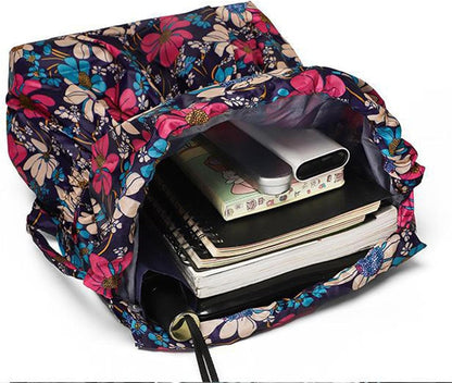 Blommig ryggsäck dam med öppen topp och synligt innandöme för förvaring